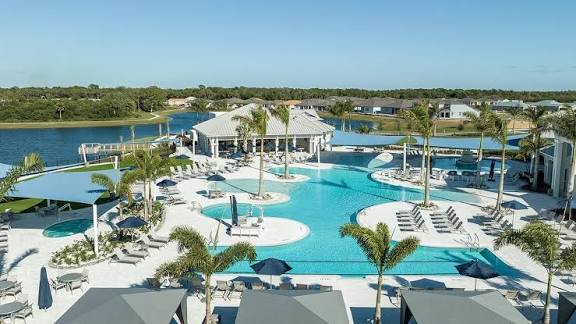 A resort-style community pool and lake setting in the Parrish area